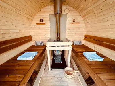 an inside view of a wooden sauna with two benches at Stuga Kodawari in Voorhout