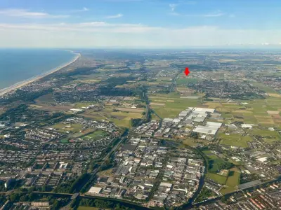 a red flag flying over a city next to the ocean at Stuga Kodawari in Voorhout