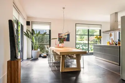 a kitchen with a wooden table and some chairs at Villa Summer in Bergen