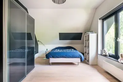 a bedroom with a bed and a glass wall at Villa Summer in Bergen