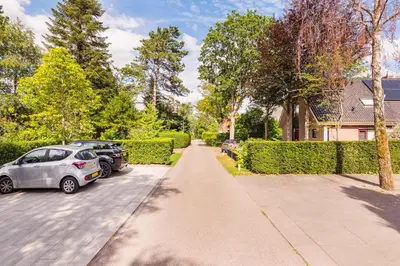 a driveway with two cars parked in front of a house at Villa Summer in Bergen