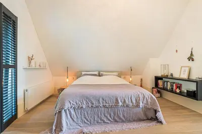 a bedroom with a large bed and a white ceiling at Villa Summer in Bergen