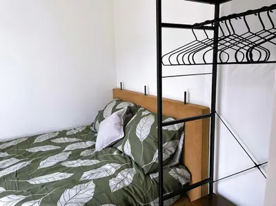 a bedroom with a bed and a black bunk ladder at Het Zonnetje in Wijk aan Zee