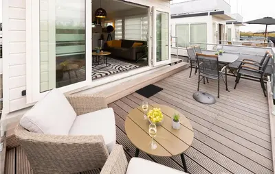 a porch with a couch and a table at 2 Bedroom Stunning Ship In Aalsmeer in Aalsmeer