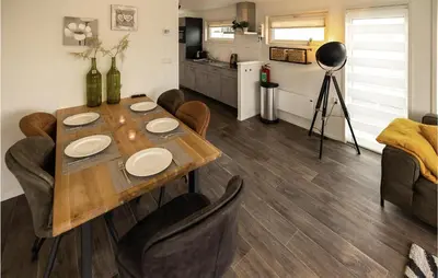 a dining room with a table and chairs and a kitchen at 2 Bedroom Stunning Ship In Aalsmeer in Aalsmeer