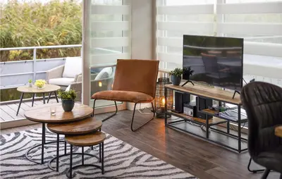 a living room with a tv and furniture on a balcony at 2 Bedroom Stunning Ship In Aalsmeer in Aalsmeer