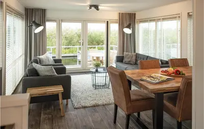 a living room with a table and a couch at 2 Bedroom Cozy Ship In Aalsmeer in Aalsmeer