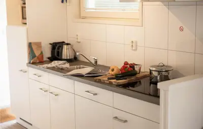 a kitchen with a sink and a counter top at 2 Bedroom Cozy Ship In Aalsmeer in Aalsmeer