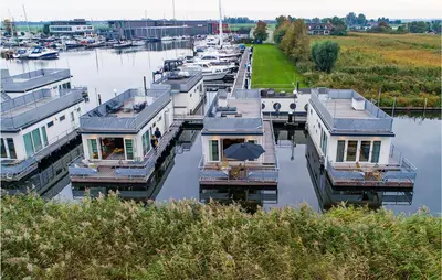 a group of boats parked in a marina at Awesome Ship In Aalsmeer With Lake View in Aalsmeer
