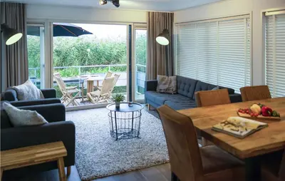a living room with a table and a couch at Awesome Ship In Aalsmeer With Lake View in Aalsmeer