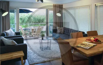 a living room with a table and a dining room at Stunning Ship In Aalsmeer With Kitchen in Aalsmeer