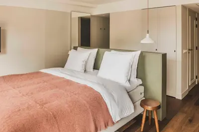 a bedroom with a large bed with white pillows at Boutique Hotel Weesp in Weesp
