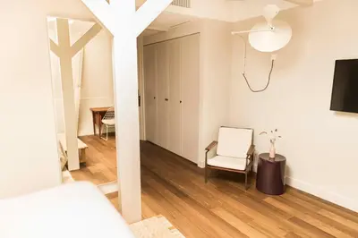 a room with a bed and a chair and a table at Boutique Hotel Weesp in Weesp