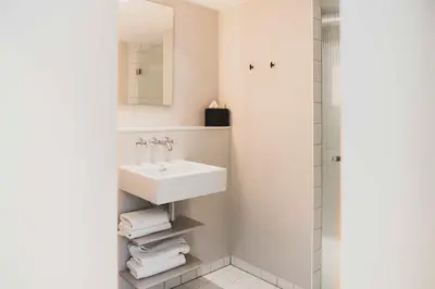 a bathroom with a sink and a shower at Boutique Hotel Weesp in Weesp