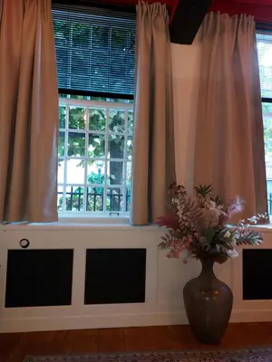 a vase of flowers sitting in front of a window at Het Waterhof in Leiden