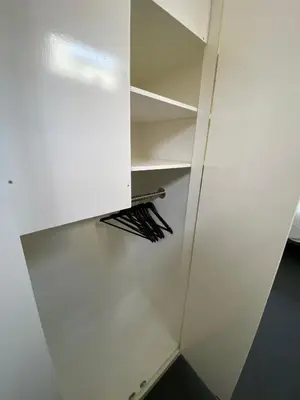 a closet with a white door and a shelf at Studio34 Zandvoort free parking in Zandvoort