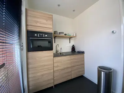 a kitchen with a sink and a microwave at Studio34 Zandvoort free parking in Zandvoort