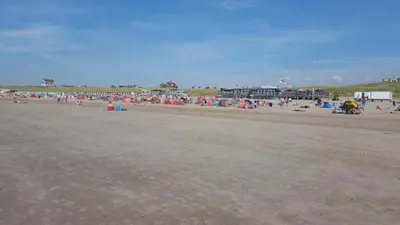 a large group of people on a beach at Pension Canberra in Bergen aan Zee