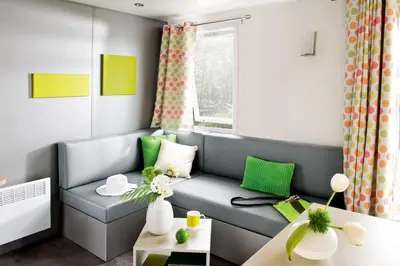 a living room with a couch and a table at Vakantiepark Koningshof in Rijnsburg