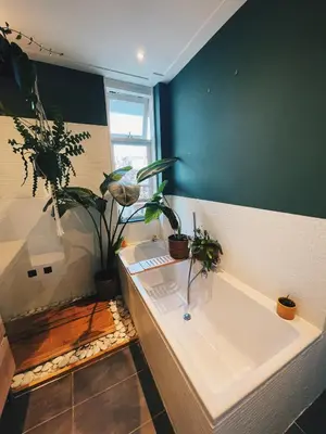 a bathroom with a bath tub with potted plants at Spacious Designer Duplex next to Central Park in Amsterdam