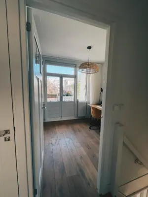 an empty hallway with a desk and a window at Spacious Designer Duplex next to Central Park in Amsterdam