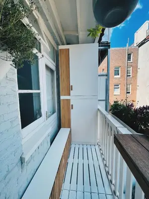 a balcony with a bench and a window at Spacious Designer Duplex next to Central Park in Amsterdam