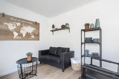 a living room with a couch and a table at Vakantiewoning 't Juttershuis Egmond aan Zee in Egmond aan Zee