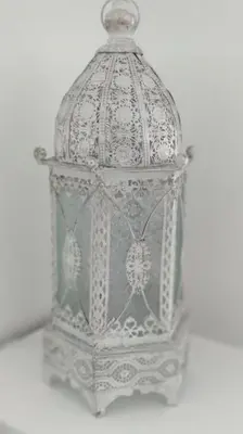 a silver bird cage sitting on a table at Amberdi Apartment Amsterdam Schiphol Airport in Hoofddorp