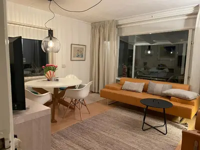 a living room with a couch and a table at appartement Ideaal in Bergen aan Zee