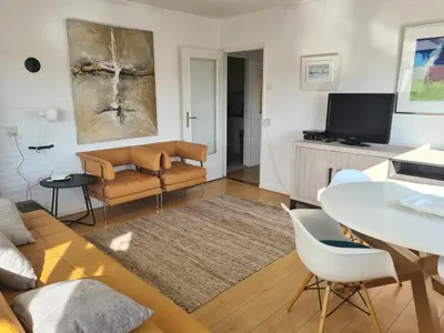a living room with a couch and a table at appartement Ideaal in Bergen aan Zee