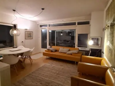 a living room with a couch and a table at appartement Ideaal in Bergen aan Zee
