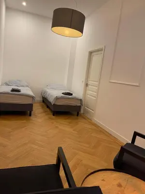 a room with two beds and a lamp at Canal House in Historic City Center Gouda in Gouda