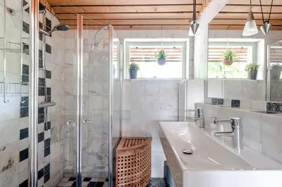 a bathroom with a sink and a glass shower at B&B De Ranck in Haarlem
