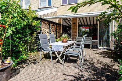 a table and chairs sitting on a patio at B&B De Ranck in Haarlem