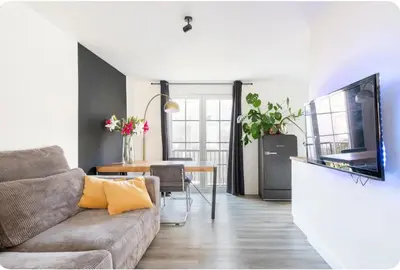 a living room with a couch and a television at Studio Romantic in Zandvoort