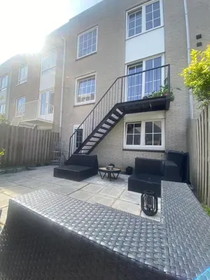 a building with a stair case and a patio at Studio Romantic in Zandvoort