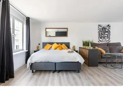a bedroom with a bed and a couch at Studio Romantic in Zandvoort