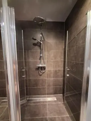 a shower with a shower head in a bathroom at B&B Zee-en-Zo Noordwijk in Noordwijk