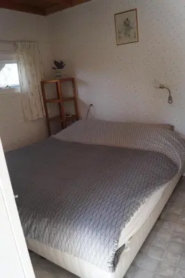 a bedroom with a large bed in a room at Hortensia Eiland in Zegveld