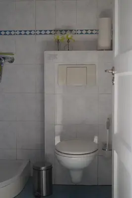 a white bathroom with a toilet and a tub at Hortensia Eiland in Zegveld