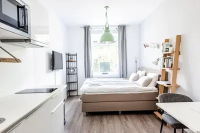 a small bedroom with a bed and a window at Studio en deluxe appartement Blueberry in Zandvoort