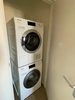 two washing machines stacked on top of each other in a room at Appartementen Zeezicht - 7 in Katwijk aan Zee