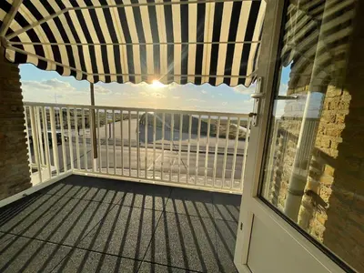 a balcony with a view of the ocean at Appartementen Zeezicht - 7 in Katwijk aan Zee