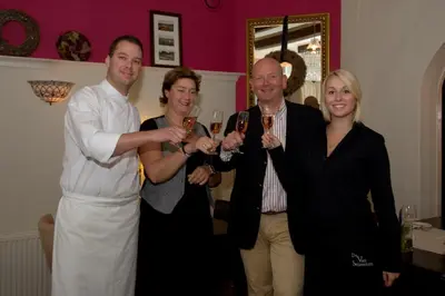 a group of people holding up glasses of wine at Bed & Breakfast De Vier Seizoenen in Lisse