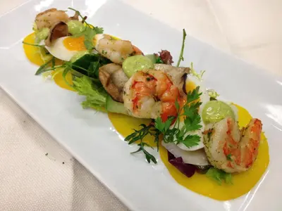 a plate of food with shrimp and vegetables on a table at Bed & Breakfast De Vier Seizoenen in Lisse