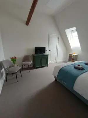 a bedroom with a bed and a green dresser at B&B Suyder Cogge in Hem