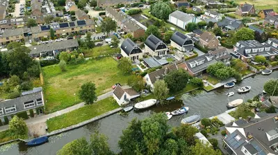 an aerial view of a town with boats in the water at Appartement YCW 'Papillon' in Rijnsaterwoude
