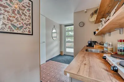 a kitchen with a wooden counter top and a sink at Appartement YCW 'Papillon' in Rijnsaterwoude
