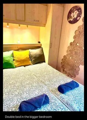 a bed in a bedroom with two pillows on it at Wellness bungalow with jacuzzi &sauna&private garden near Amsterdam in Vijfhuizen