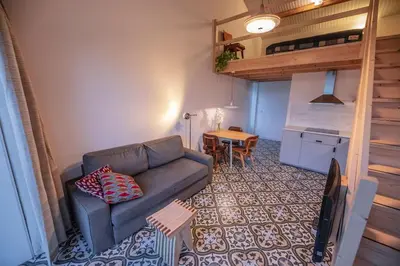 a living room with a couch and a table at 't Winkeltje - Vakantiehuisje op boerderij Huize Blokland in Hem